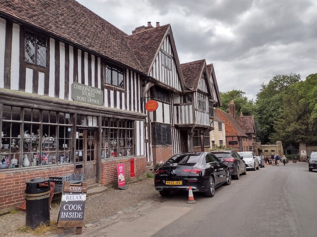 OLd timber framed buildings down one side of a small road
