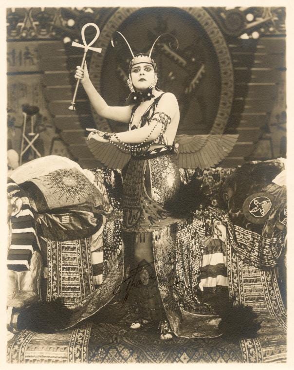 Publicity photo from the 1917 film Cleopatra. Photo of Bara in Egyptian royal garb holding an ankh aloft and gazing imperiously into the camera. Publicity photo from the 1917 film Cleopatra. Photo of Bara in Egyptian royal garb holding an ankh aloft and gazing imperiously into the camera.