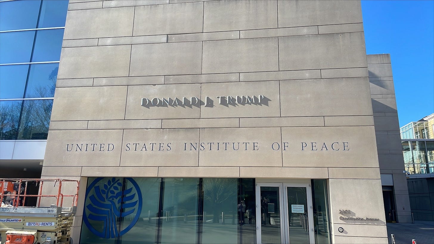 The U.S. Institute of Peace building with Donald J. Trump lettering above its carved name The U.S. Institute of Peace building with Donald J. Trump lettering above its carved name