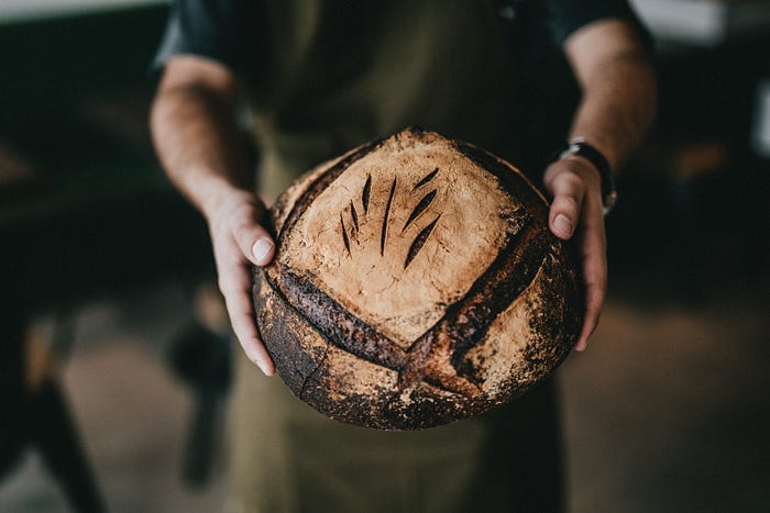 A rustic loaf of artisan sourdough bread. A rustic loaf of artisan sourdough bread.