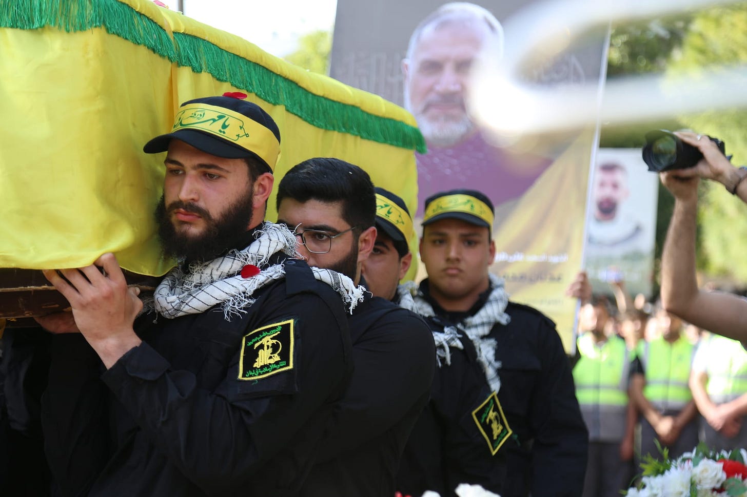 Hezbollah members carry the yellow flag-draped coffin of a senior official during his funeral in southern Lebanon. Hezbollah members carry the yellow flag-draped coffin of a senior official during his funeral in southern Lebanon.