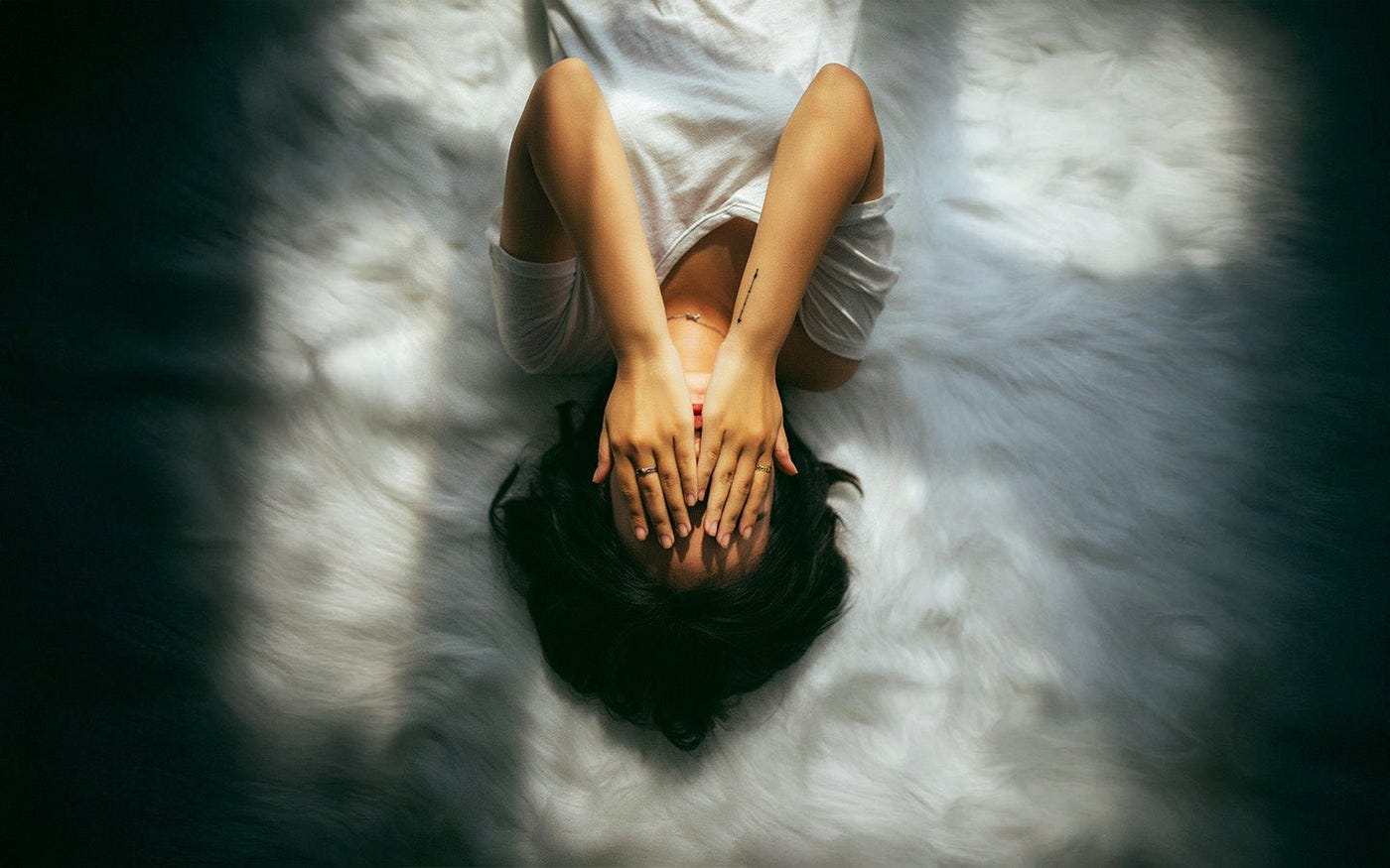 Woman with hands over her face