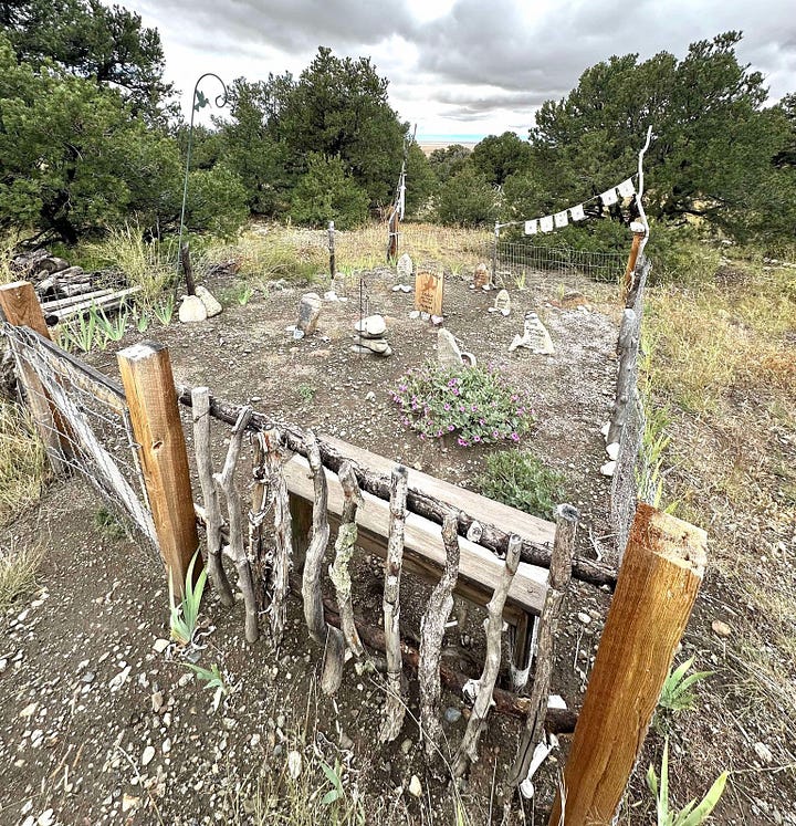On the left, several headstones inside a wrought iron fence. On the right, rocks and headstones within a wooden fence.