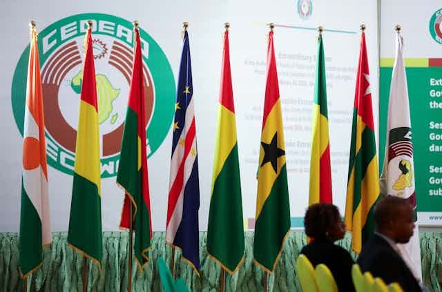 Flags of different countries lined up in a room Flags of different countries lined up in a room