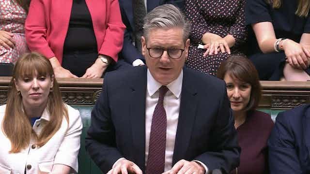 Close up of Keir Starmer with MPs sitting in background Close up of Keir Starmer with MPs sitting in background