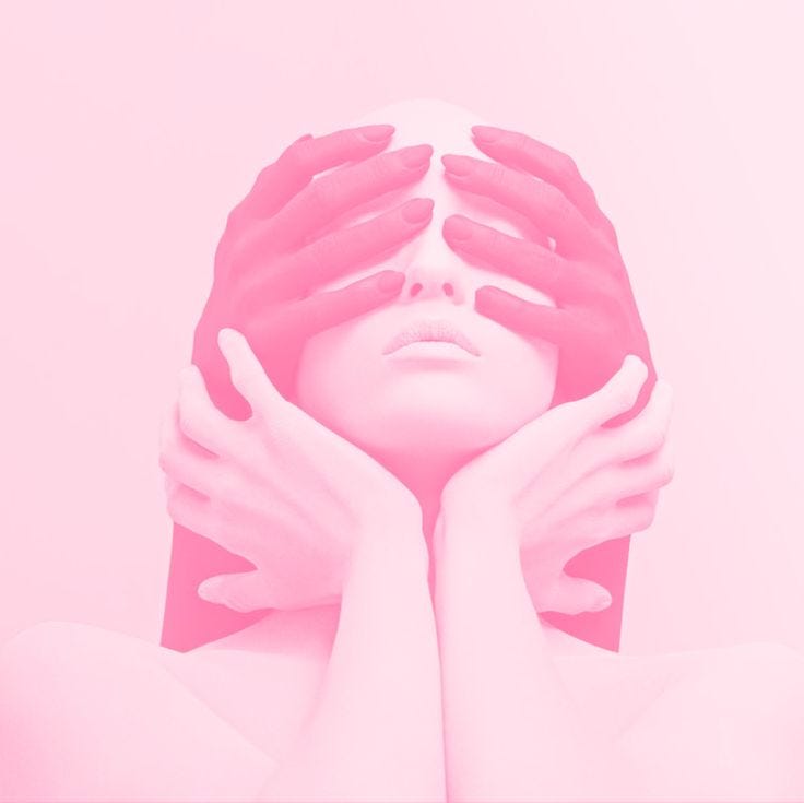 This may contain: a woman with her hands on her face