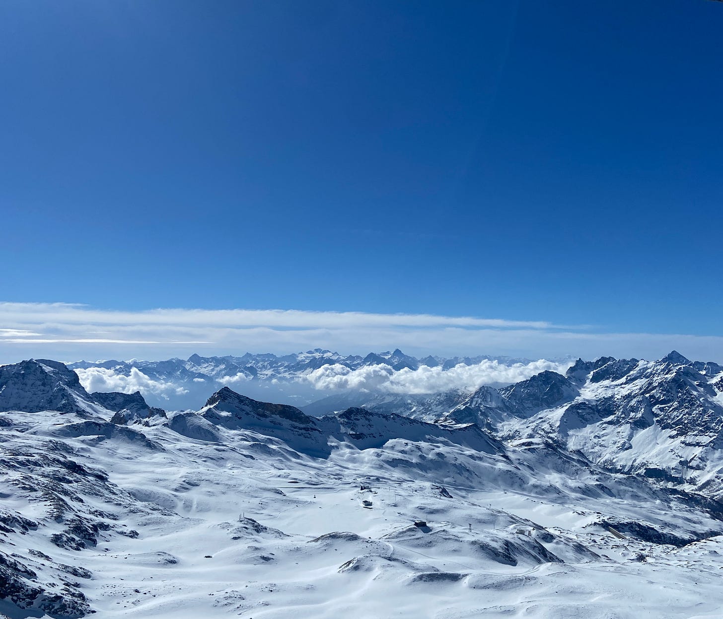 Snow capped mountain range with blue sky