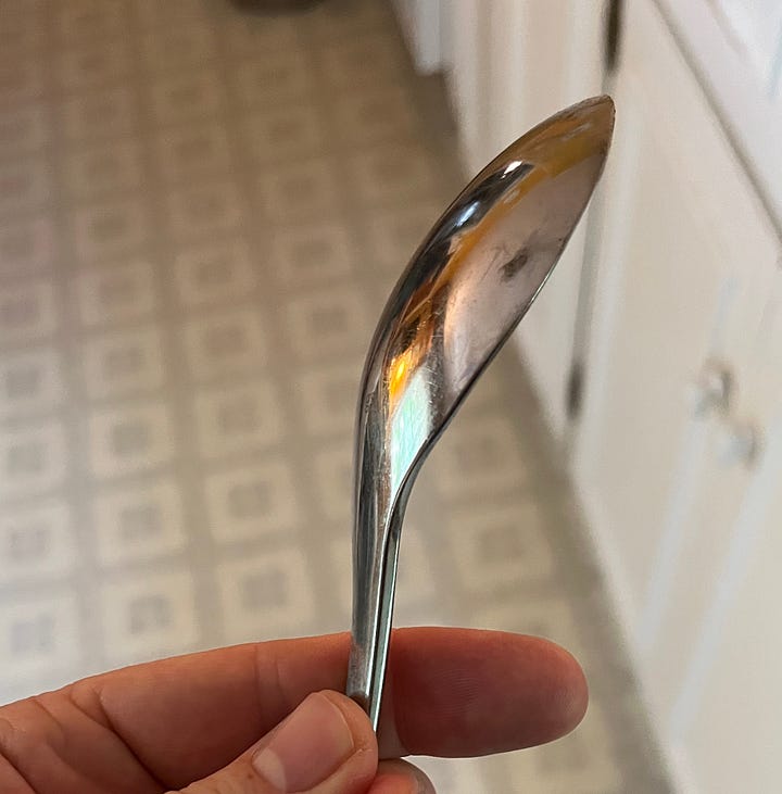 Two images of spoons from my kitchen. One is a soup spoon with a particularly large, round head (it's more like a small ladle, really). The other spoon is sleaker from handle to head, with an elongated bowl that looks almost fururistic.