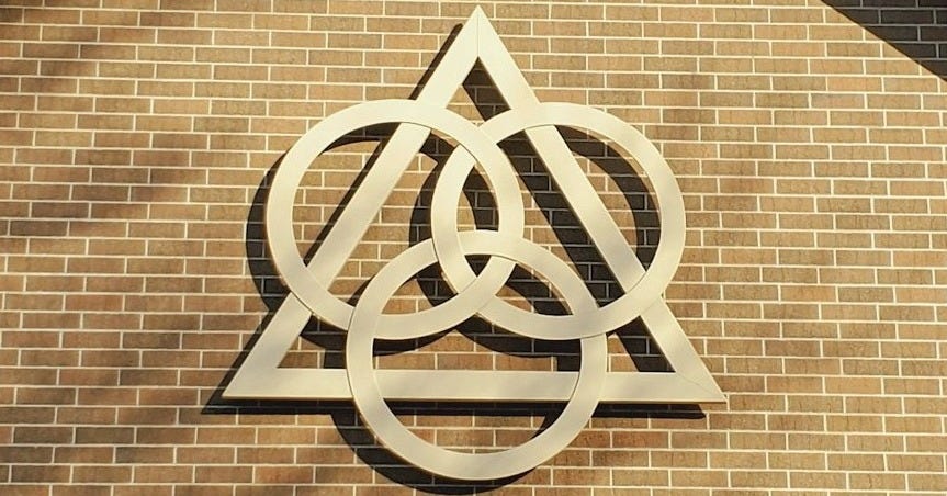brown brick wall with white cross