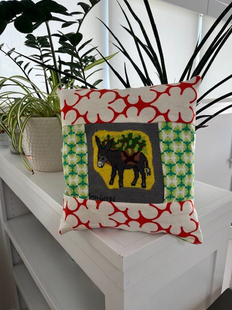 picture of a needlepoint donkey and then one of the donkey in a pillow.