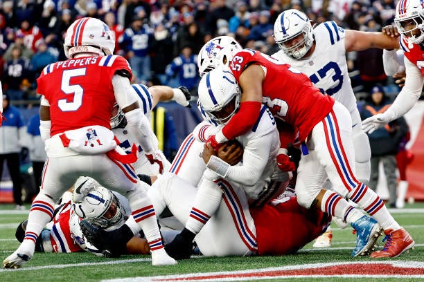 Anthony Richardson of the Indianapolis Colts scores a two point conversion against Christian Elliss and Jabrill Peppers of the New England Patriots...