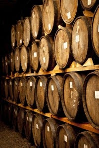 Rows of full barrels signal good news for consumers; for wineries, not so much. Rows of full barrels signal good news for consumers; for wineries, not so much.