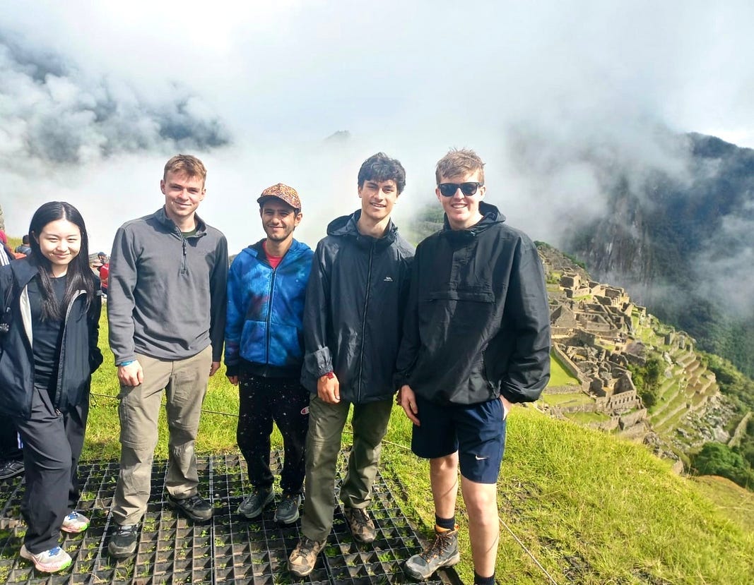Exhausted author and friends standing atop Macchu Pichu, unscathed by fire ants