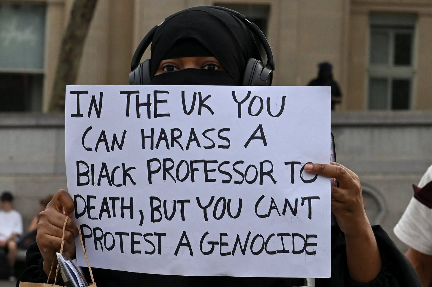 May be an image of one or more people and text that says 'IN THE UK YOU CAN HARASS A BIACk PROFESSOR TC DEATH, BUT γου CAN'T PROTEST A GENOCIDE' May be an image of one or more people and text that says 'IN THE UK YOU CAN HARASS A BIACk PROFESSOR TC DEATH, BUT γου CAN'T PROTEST A GENOCIDE'