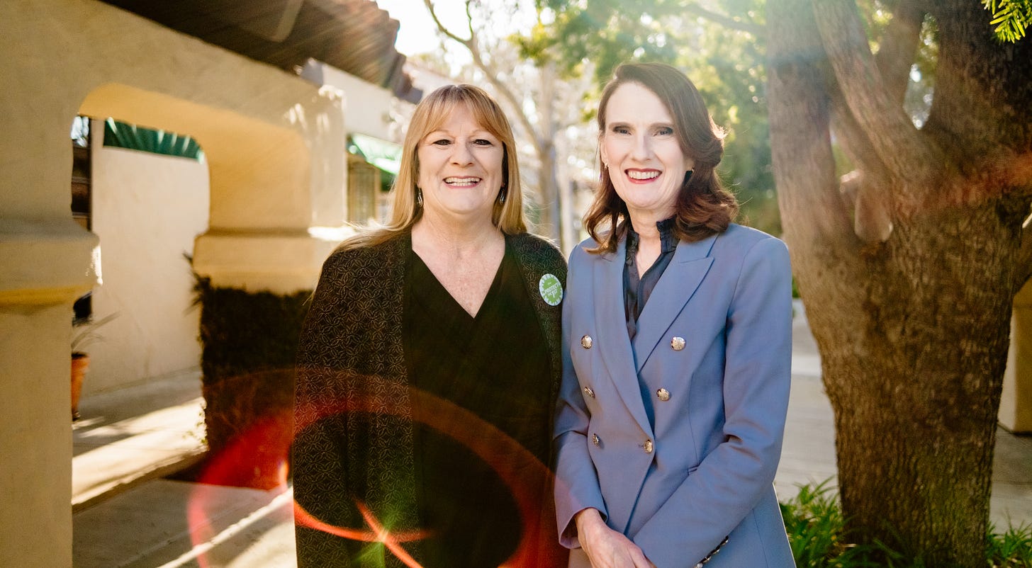 Two women standing next to each other and facing the camera