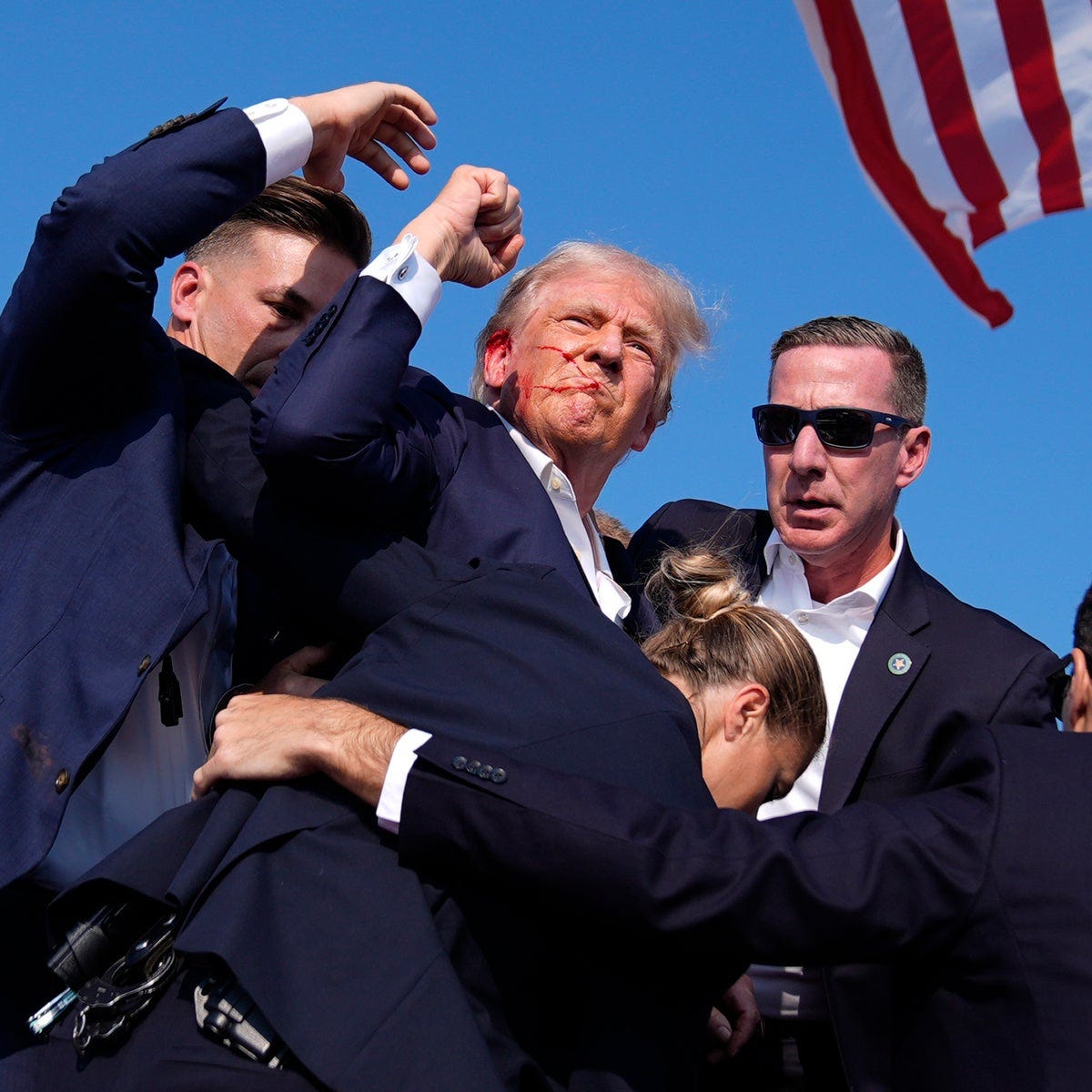 Amid chaos and gunfire, Trump raised his fist and projected a  characteristic image of defiance | The Independent
