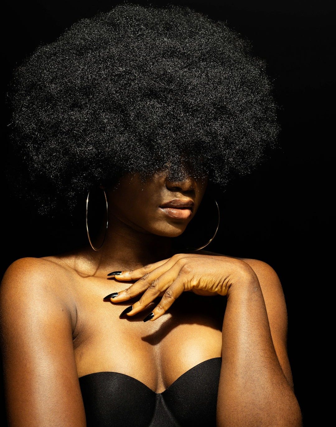 topless woman with black curly hair