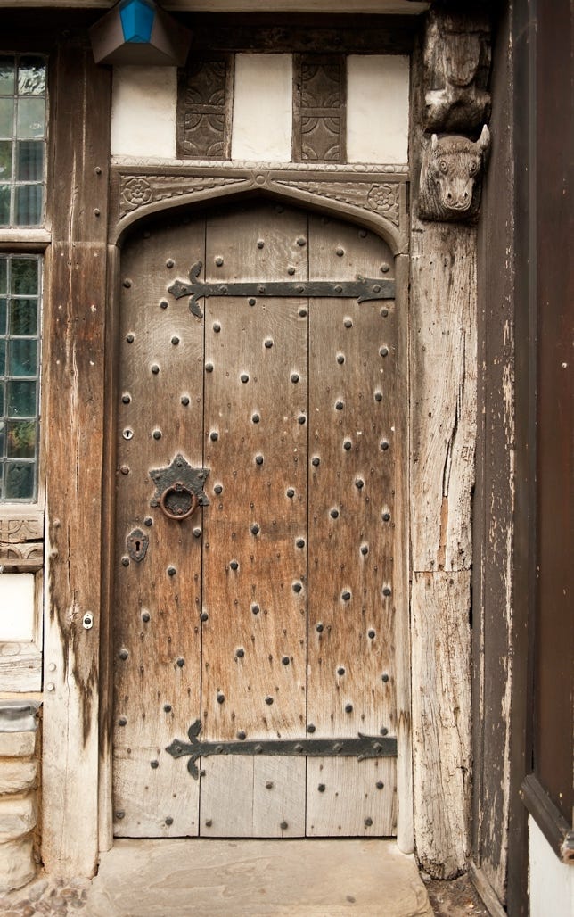 A wooden door with a metal handle

Description automatically generated