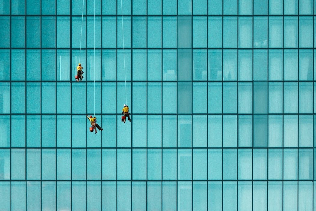 three men cleaning windows