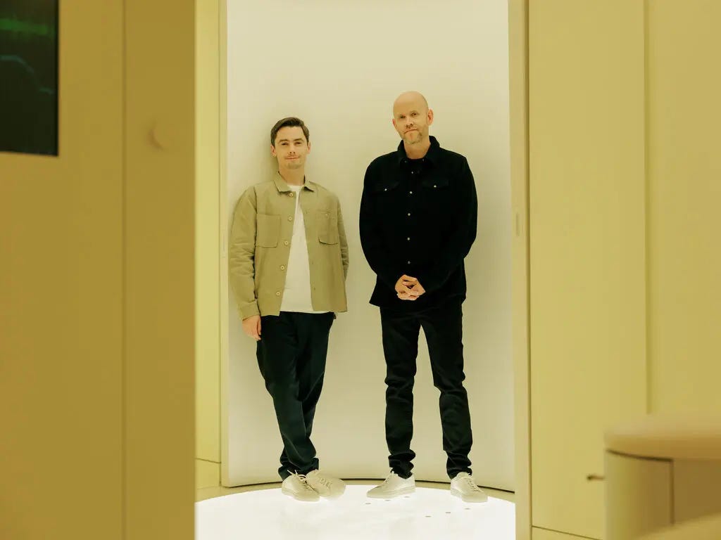 Hjalmar Nilsonne and Daniel Ek face the camera while standing with their backs against a well-lit wall. Hjalmar Nilsonne and Daniel Ek face the camera while standing with their backs against a well-lit wall.