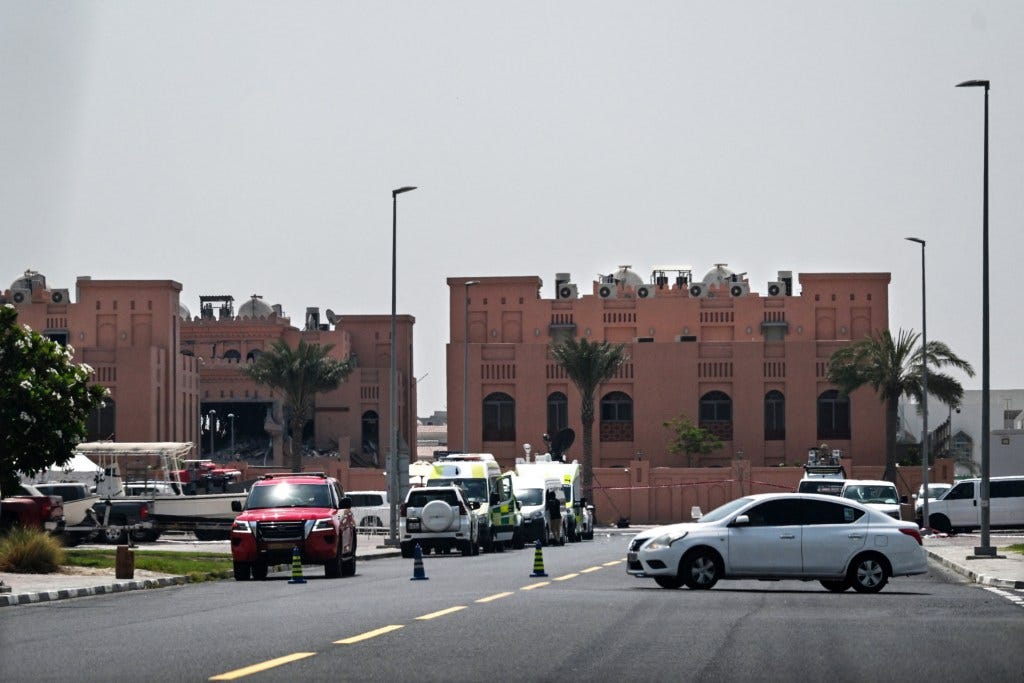 A picture taken from a distance shows the damaged building (L) in the compound housing members of Palestinian militant group Hamas's political bureau