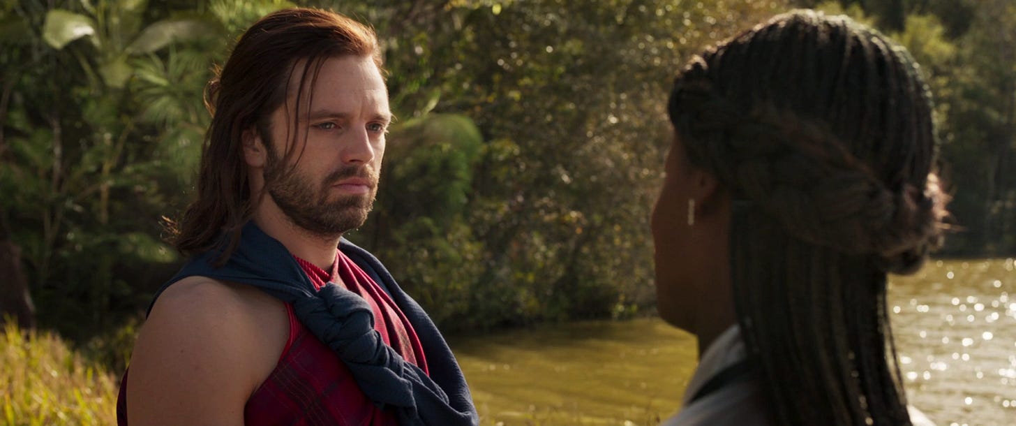 Bucky with his hair down looking stoicly at Shuri