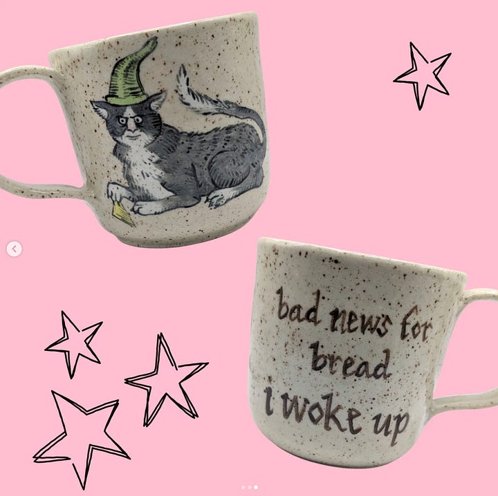 Photo One: a handmade ceramic mug with a medieval cat illustration on one side and the quote, "Bad news for bread, I woke up." on the other.  Second photo: handmade silver pendant of a sun and moon.