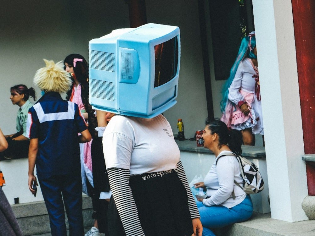 a group of people standing around a building a group of people standing around a building