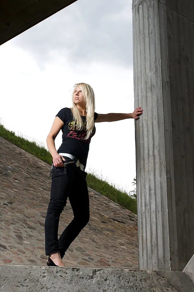 A young woman in summer 2009 embracing the sleek, often monochromatic, all-black aesthetic popular towards the decade's end. A young woman in summer 2009 embracing the sleek, often monochromatic, all-black aesthetic popular towards the decade's end.