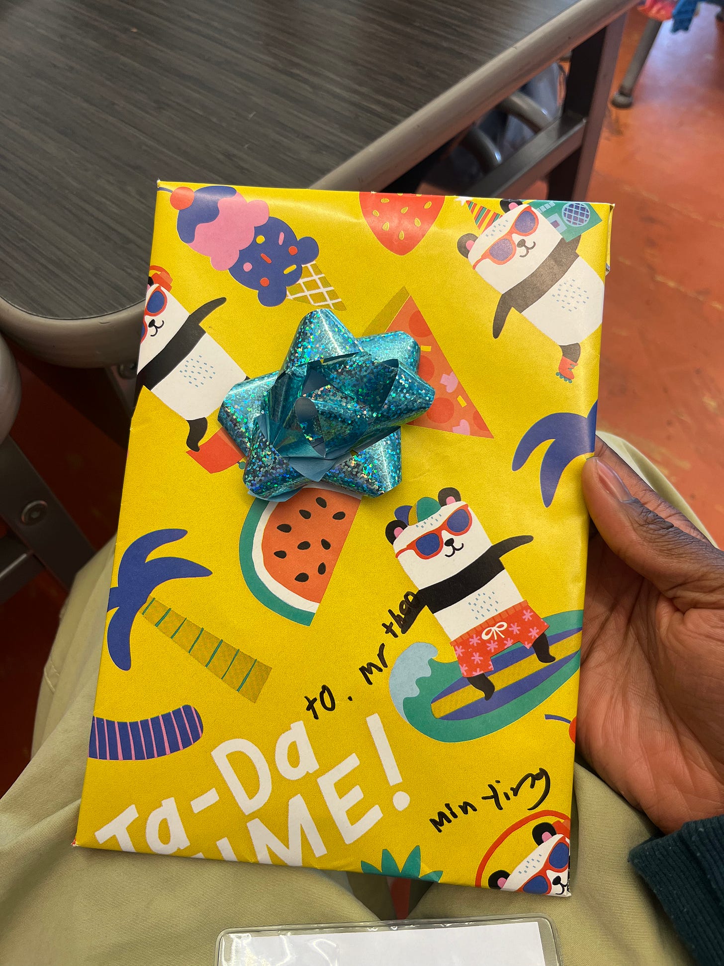A sketchbook wrapped in paper and a bow