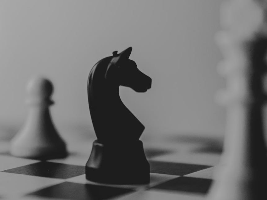 black horse chess piece near roque chess piece black horse chess piece near roque chess piece