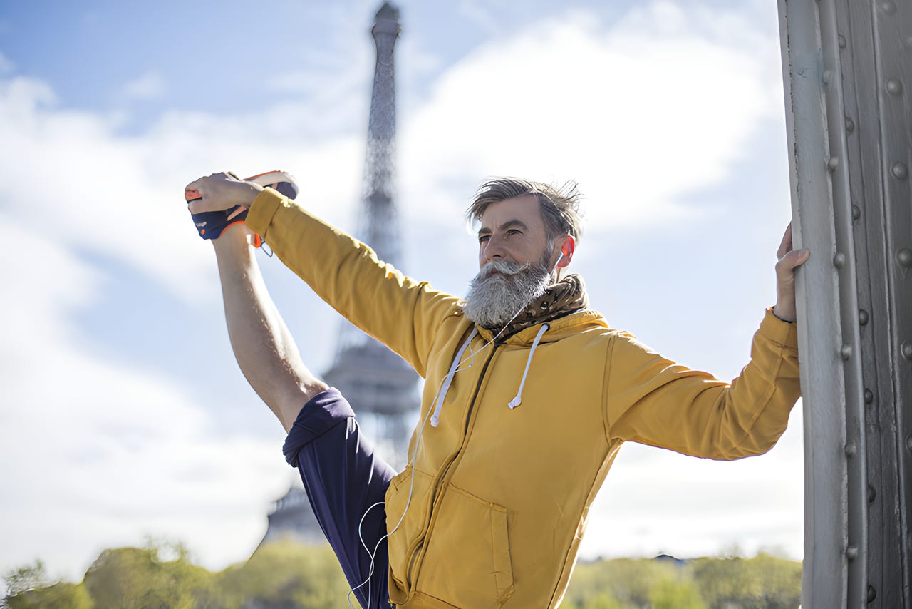 Man stretching in front of the Eiffel Tower