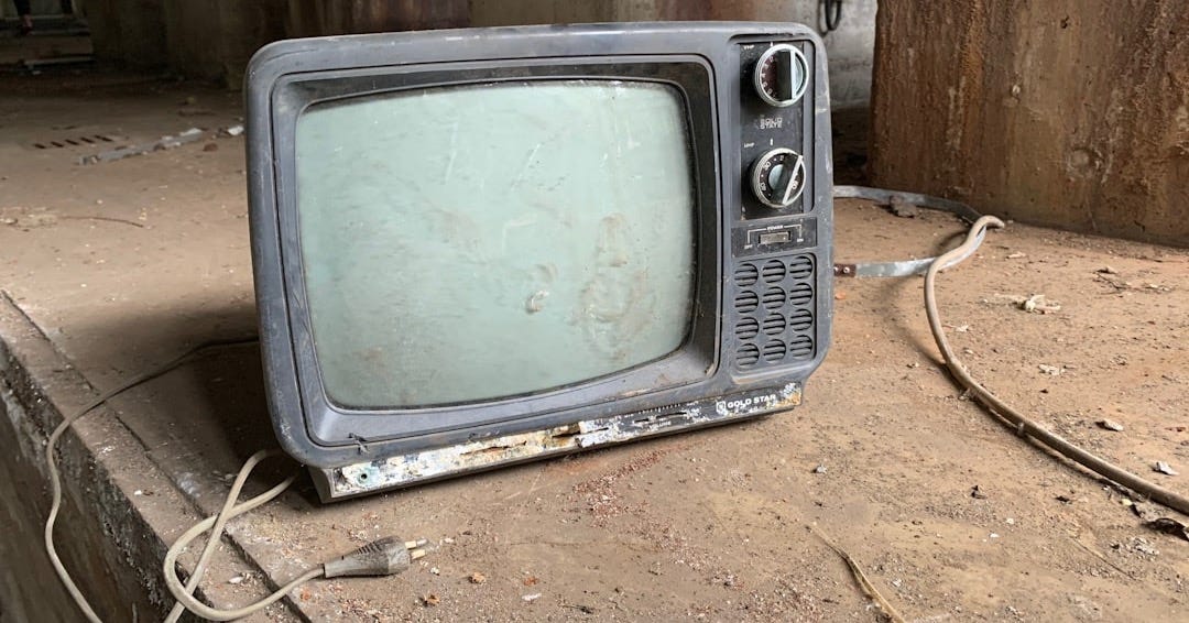 gray crt tv on brown soil gray crt tv on brown soil