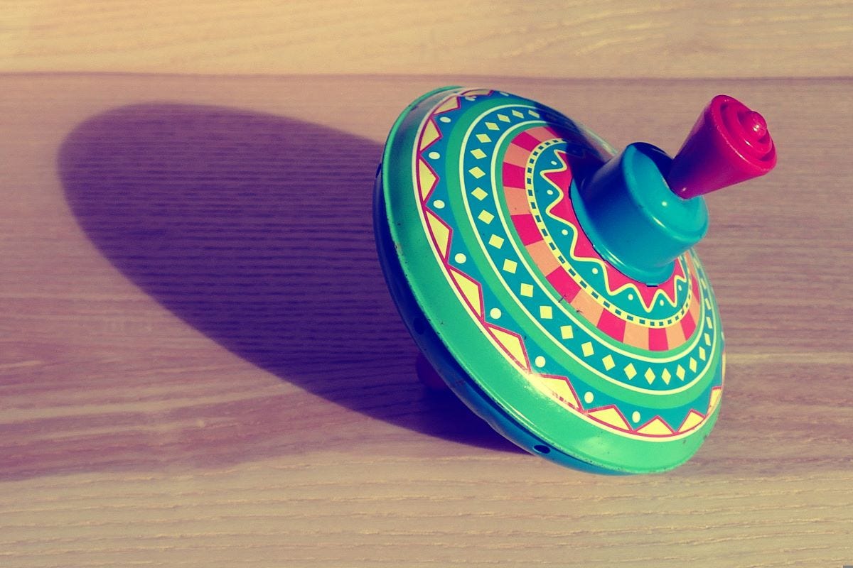 Picture of colourful spinning top on table