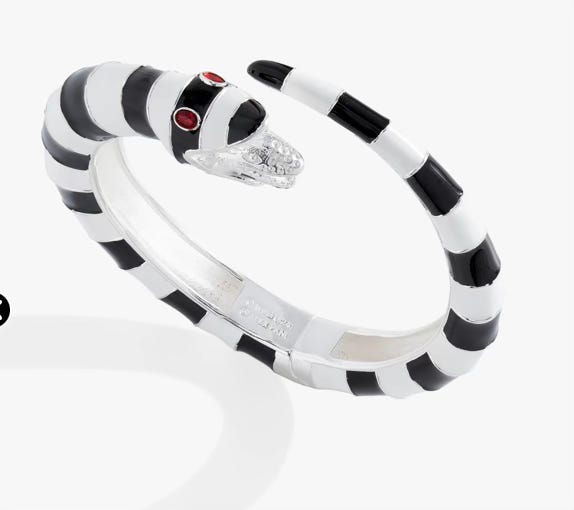 a cuff bracelet designed to look like one of the sandworms from Beetlejuice with red eyes