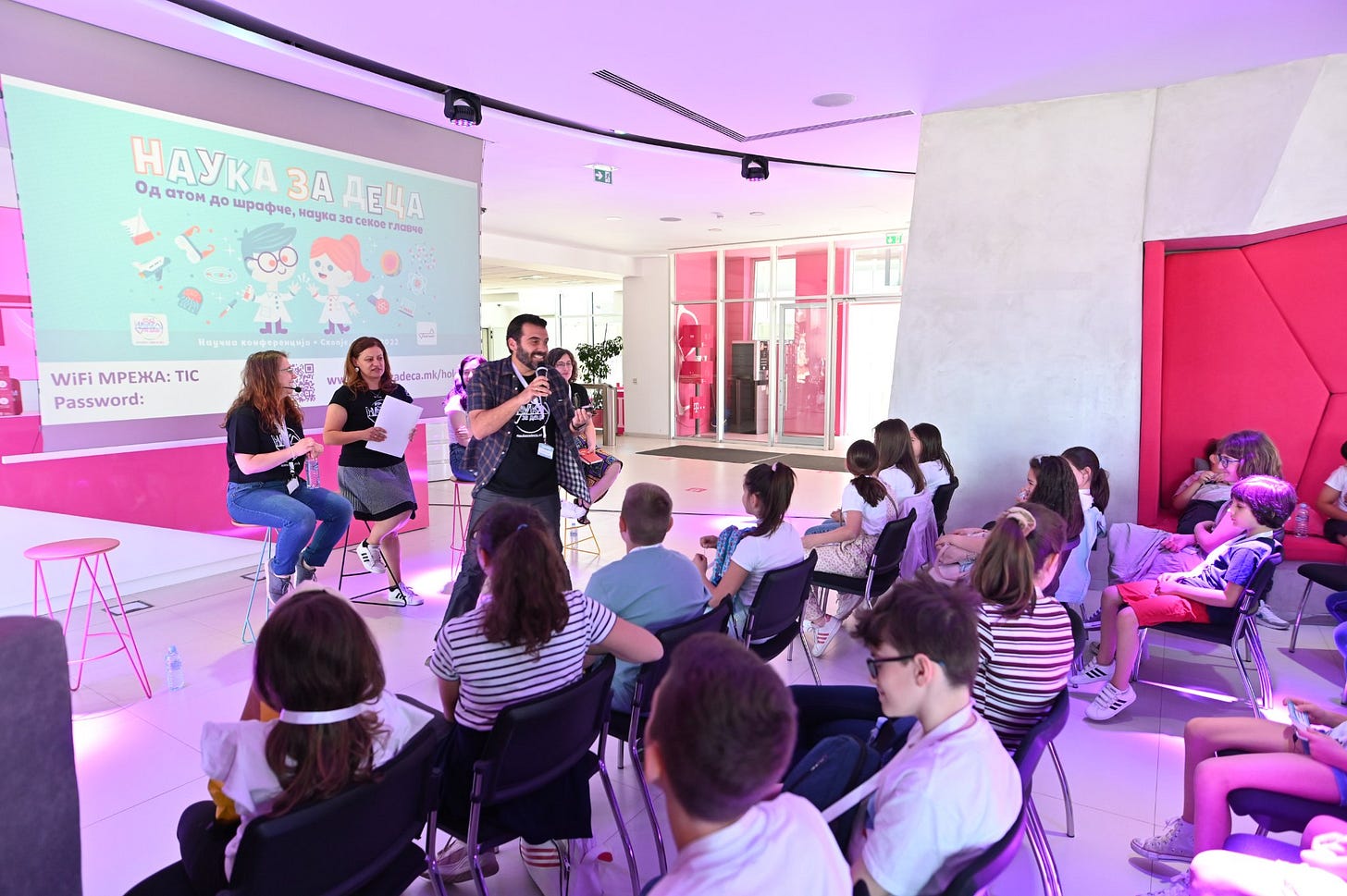 May be an image of 15 people, people sitting, people standing and indoor