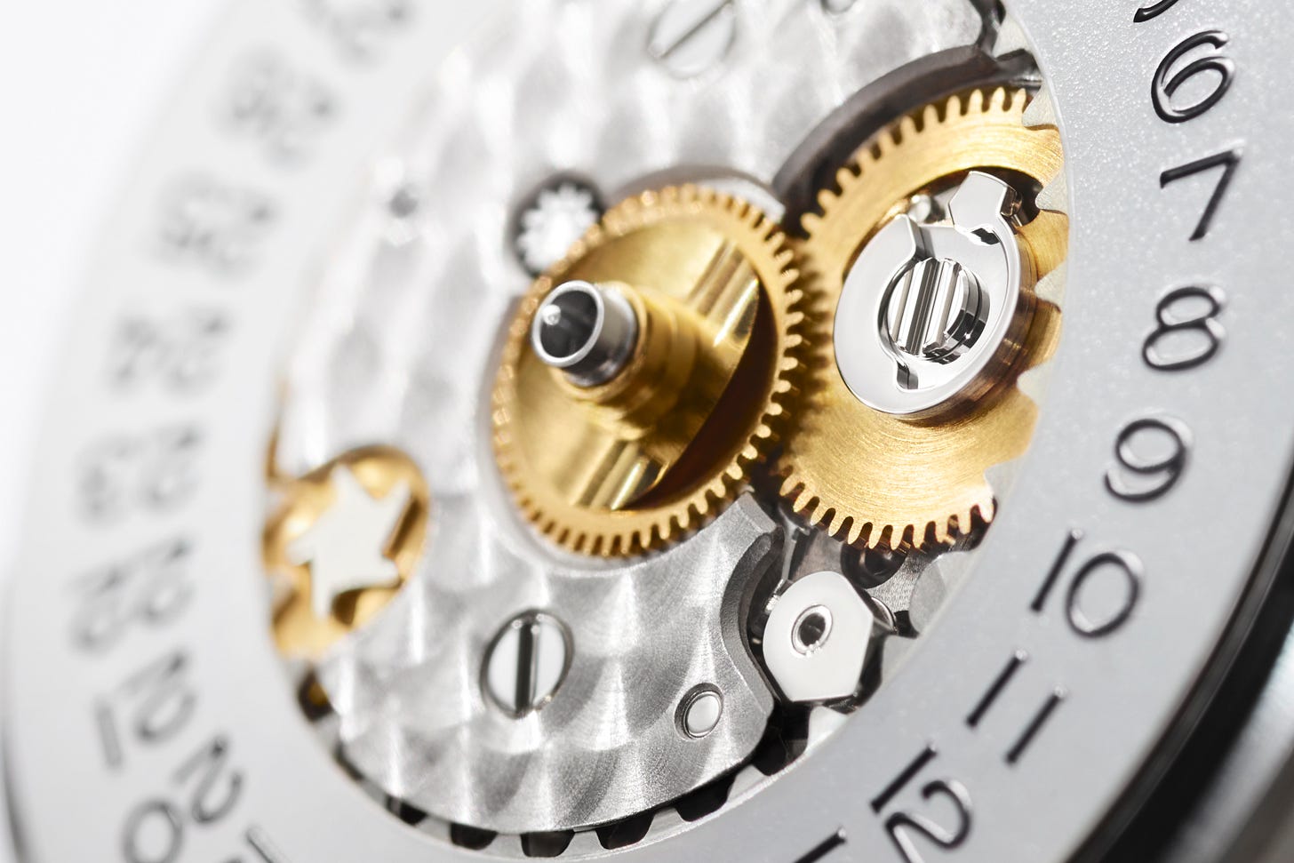 A photograph of the dial side of the Rolex caliber 2236 movement, featuring elegant perlage on the bridge surrounded by the date wheel.