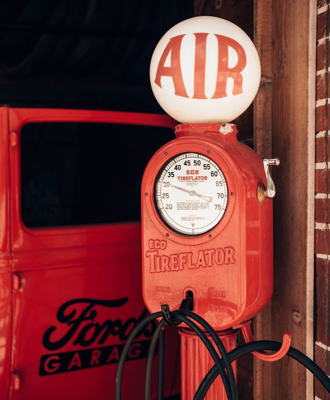 a red truck with an air gauge on top of it