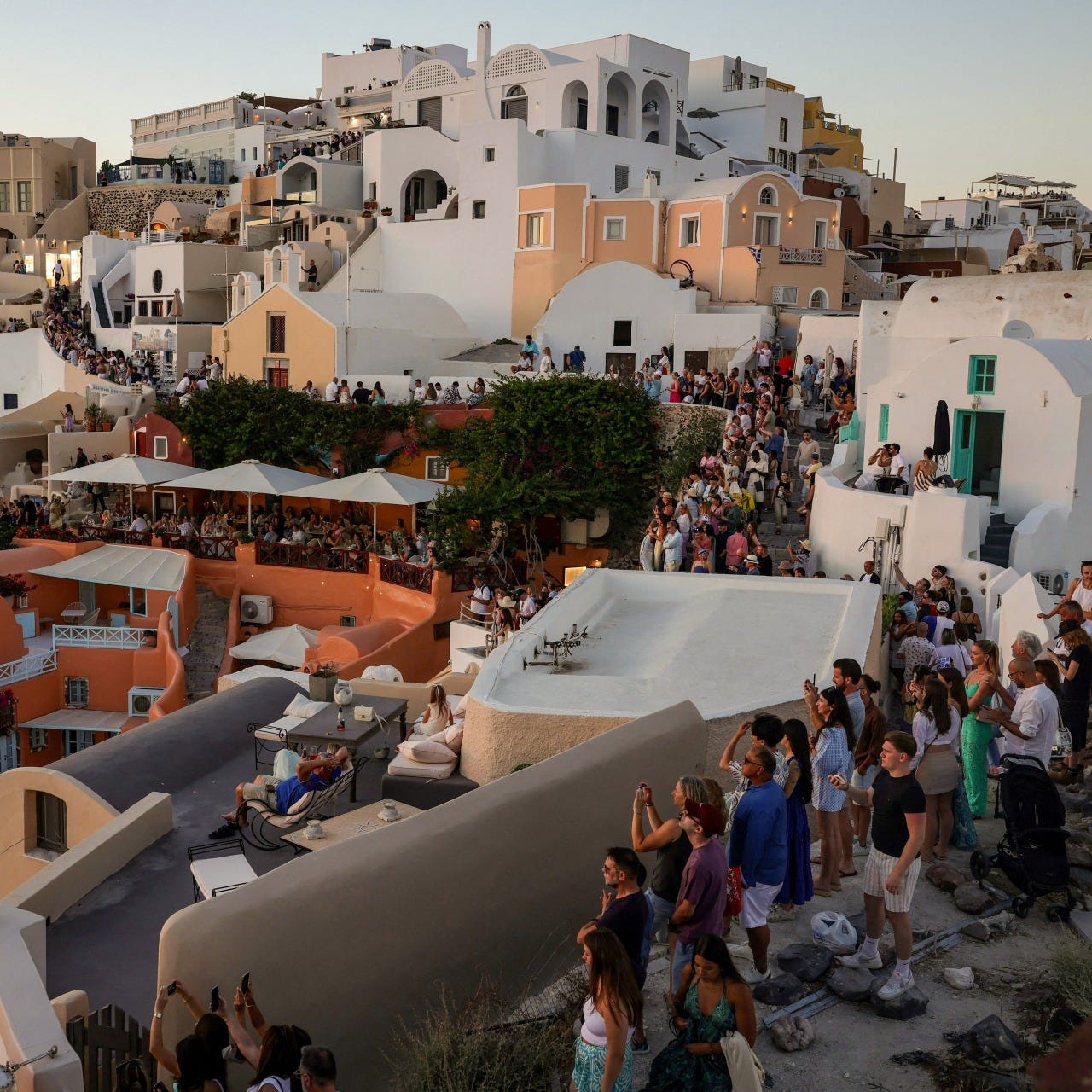 Thousands of tourists gather in the village of Oia on Santorini, Greece, to watch the sunset.