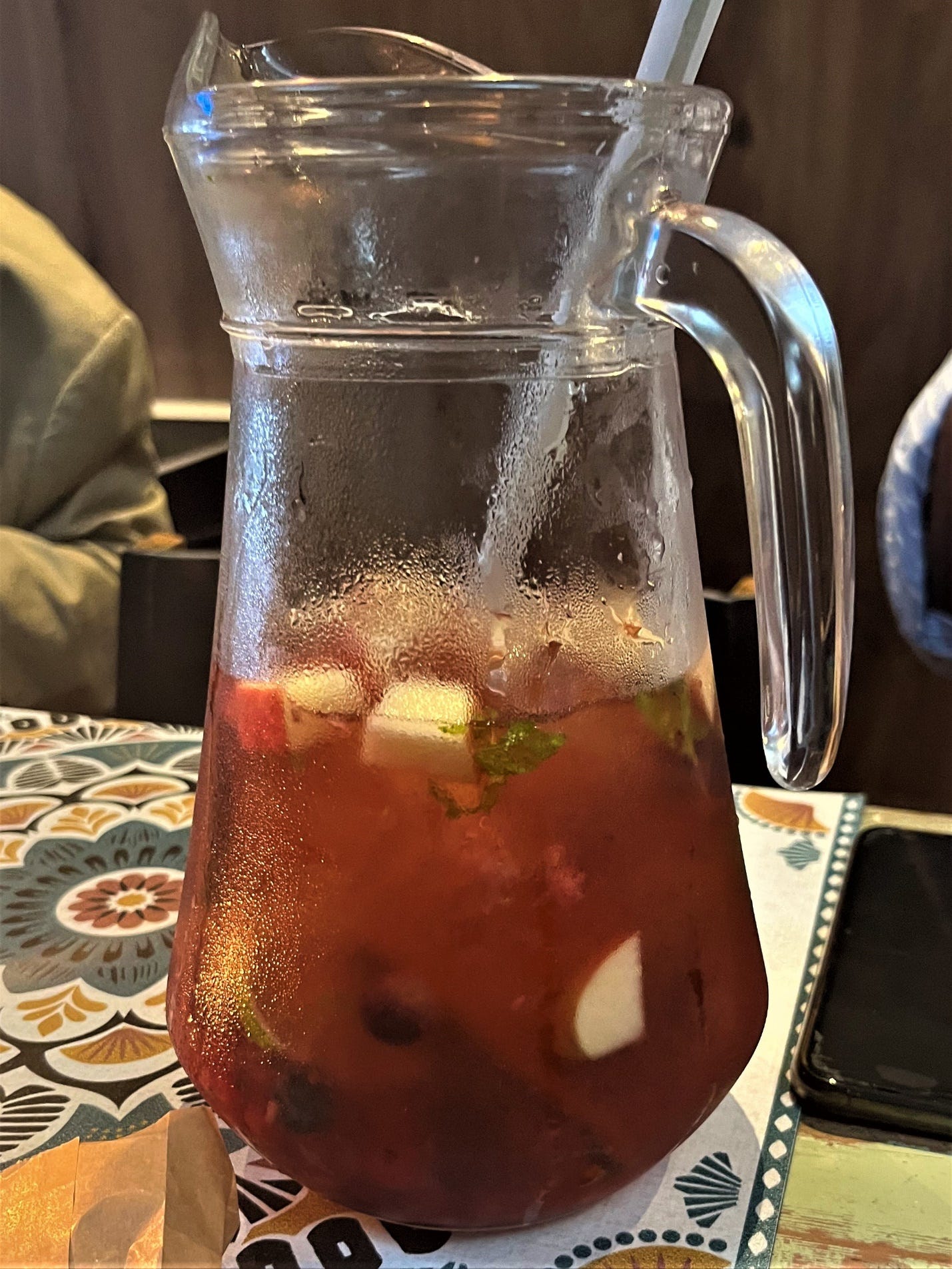A pitcher of liquid with a straw

Description automatically generated