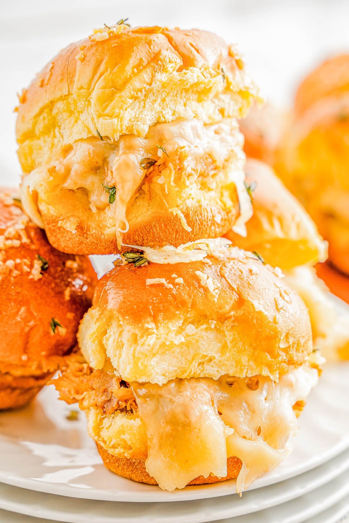 Barbecue Chicken Sliders - These FAST and EASY sliders are made with shredded chicken, smothered in tangy barbecue sauce, sandwiched between soft slider buns with cheese, and baked until warm! These pull-apart sandwiches are perfect for parties, game days, or any casual gathering where a simple appetizer or snack is needed!