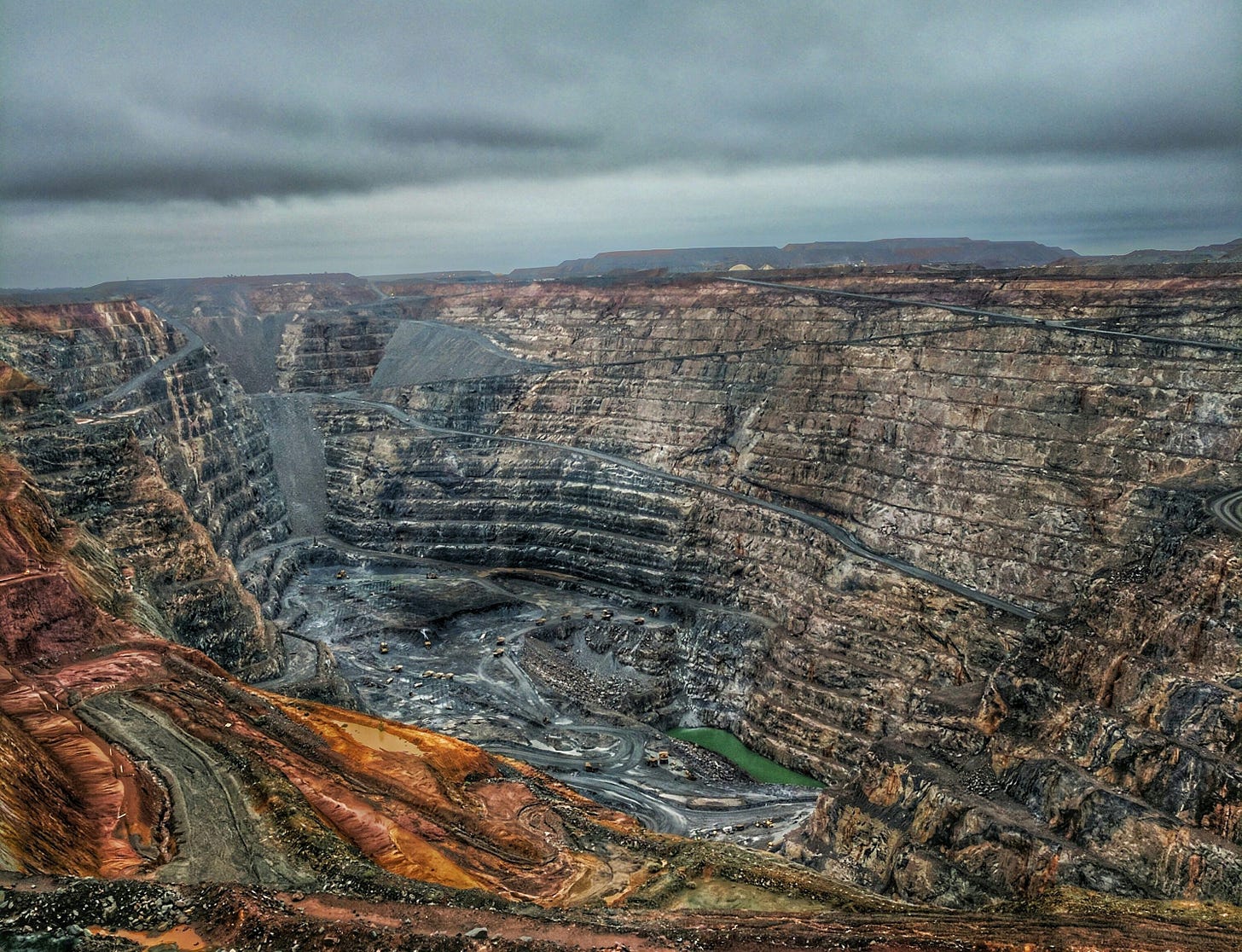 a view of a large open pit in the middle of nowhere