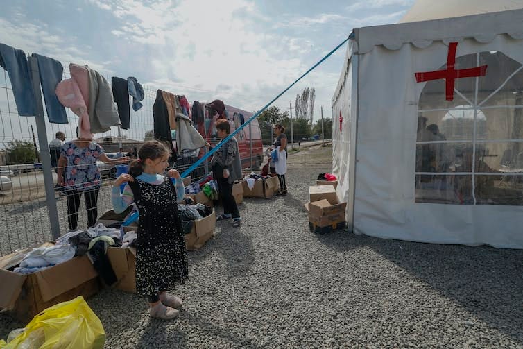 Clothes hand out on a makeshift washing line outside a tent at a refugee camp Clothes hand out on a makeshift washing line outside a tent at a refugee camp