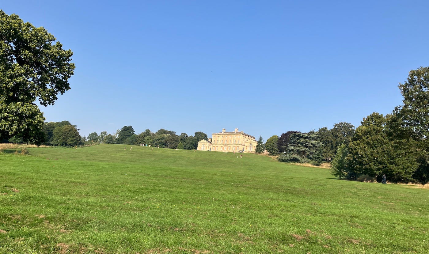 Hall seen at the far end of a field