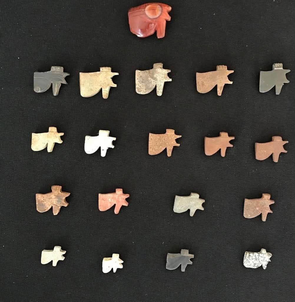 A collection of Eye of Horus amulets in varied stones and colors, part of the burial assemblage uncovered at the Quesna necropolis. A collection of Eye of Horus amulets in varied stones and colors, part of the burial assemblage uncovered at the Quesna necropolis.