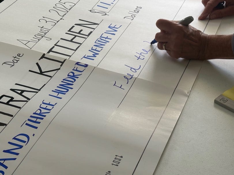 A person writing on a check

AI-generated content may be incorrect.
