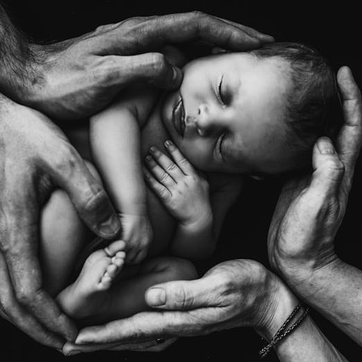 grayscale photo of woman hugging baby