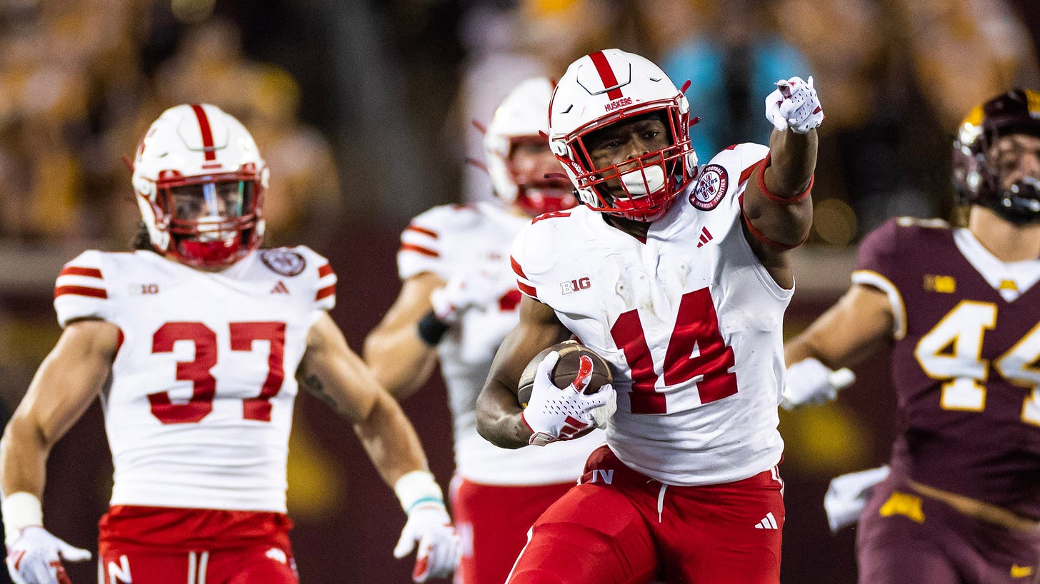 Nebraska running back Rahmir Johnson signals first down during a game against Minnesota.