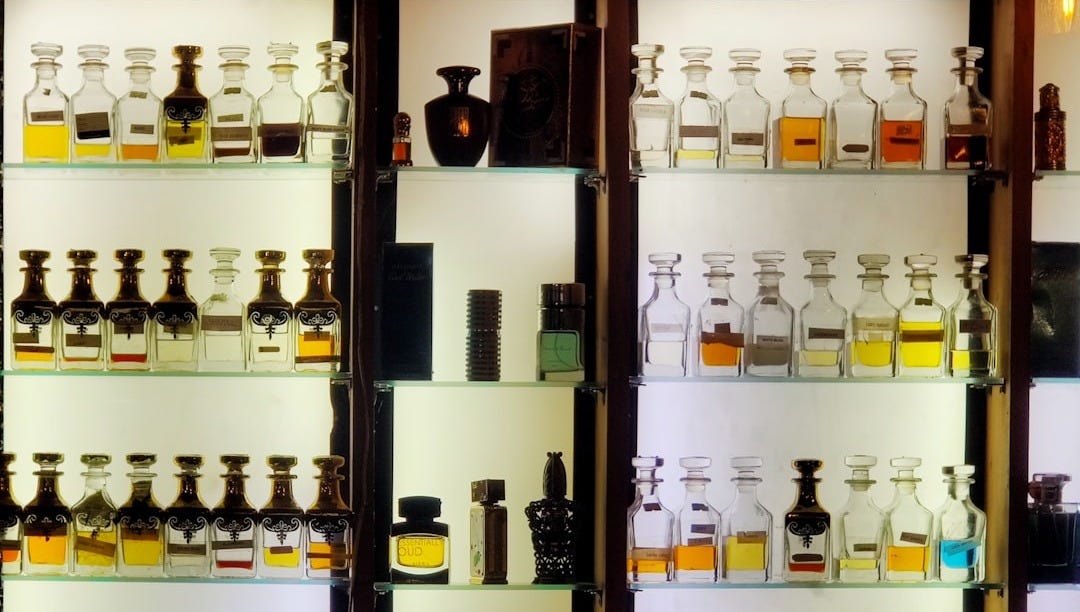 bottles on brown wooden shelf