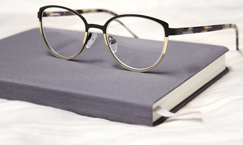 black framed eyeglasses on black book